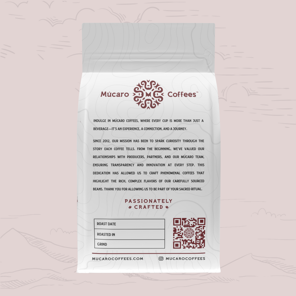 A white bag of Mucaro Coffee's 'Passionately Crafted' coffee stands against a light pink background with faint line drawings of mountains and clouds. The bag features a gray top seal, black descriptive text, and dark red branding and logo details.