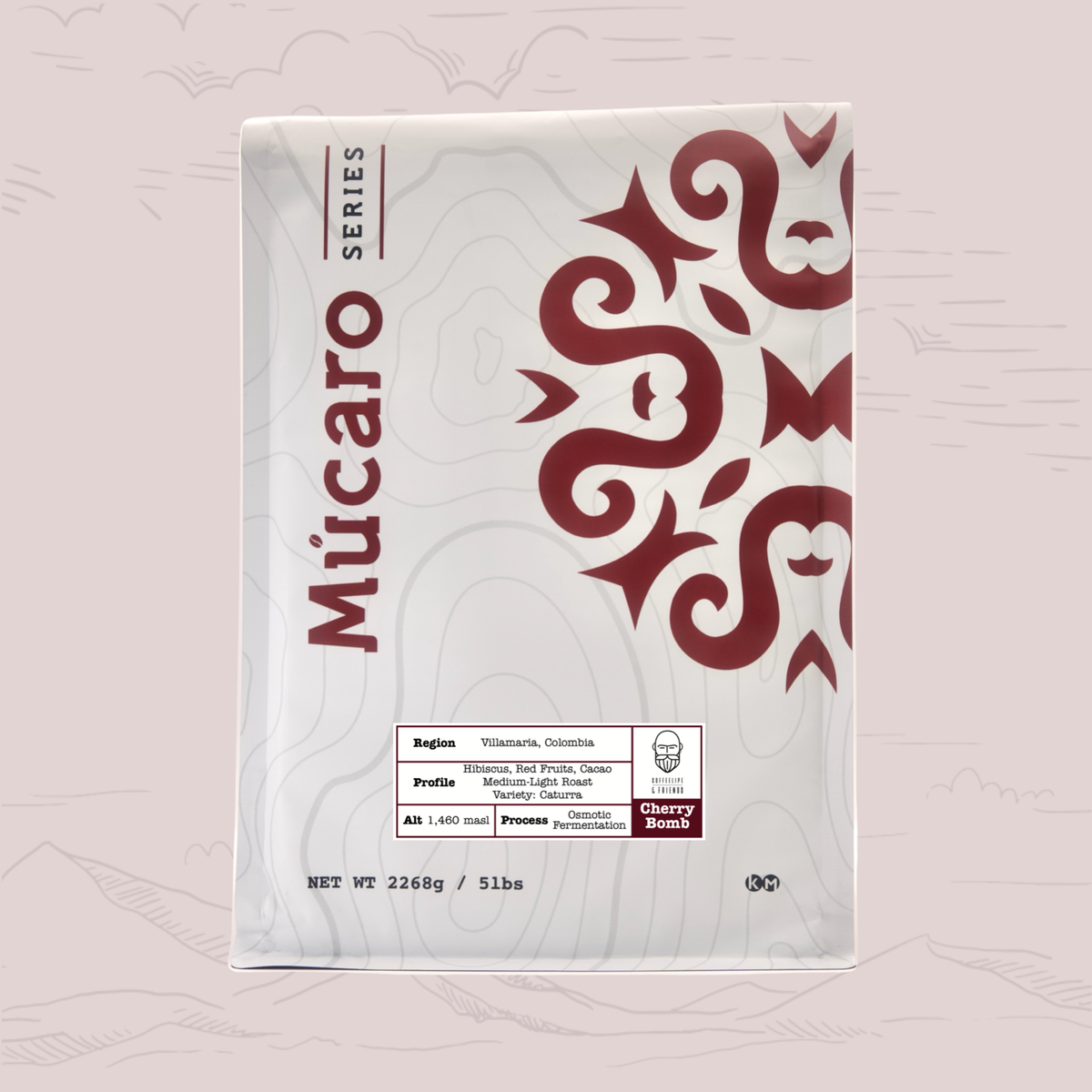 A package of Mucaro Series coffee of Cherry Bomb from Colombia, featuring a white bag with a dark red snake graphic and product details on a light pink background.