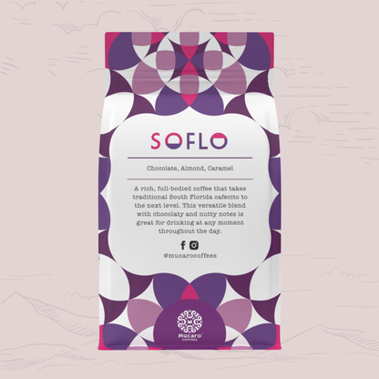 A stand-up coffee bag from Mucaro Coffees with a white center label and a geometric pattern in purple, magenta, and white around the edges. The label reads 'SOFLO' and 'Chocolate, Almond, Caramel.