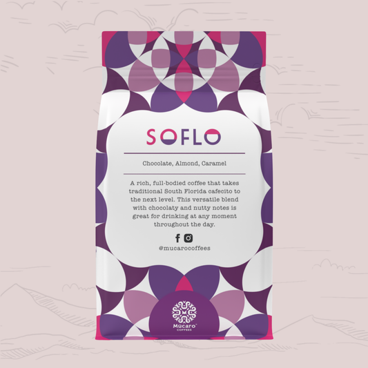 A stand-up coffee bag from Mucaro Coffees with a white center label and a geometric pattern in purple, magenta, and white around the edges. The label reads 'SOFLO' and 'Chocolate, Almond, Caramel.
